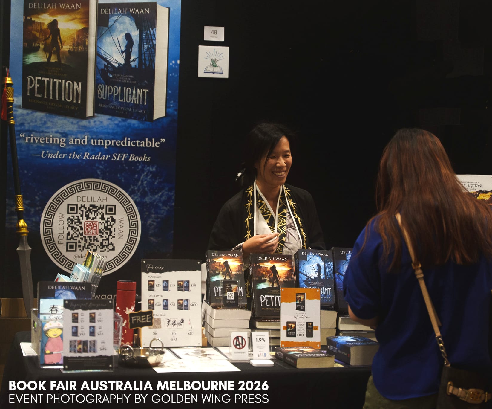 Photograph of Delilah Waan at her stall at Book Fair Melbourne Australia 2026. Event photography by Golden Wing Press.
