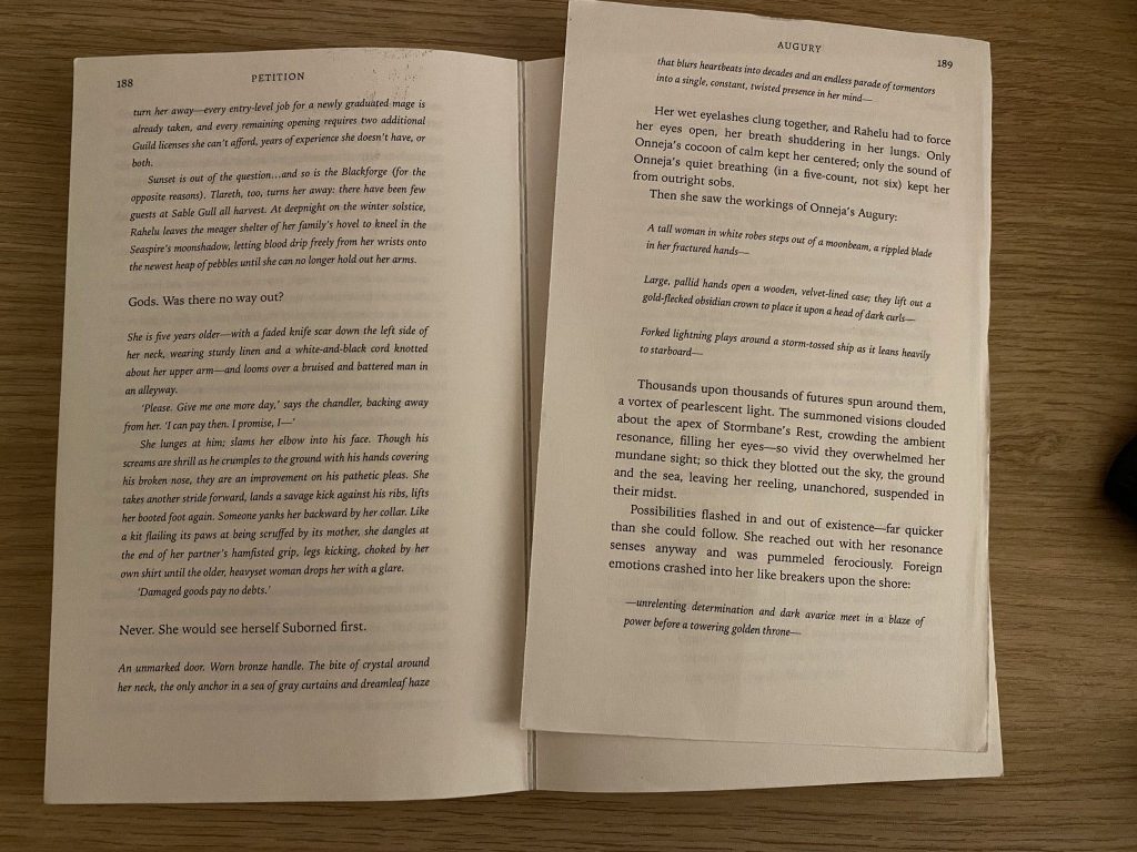 Photo of a battered print-on-demand paperback edition of Petition by Delilah Waan, lying flat and opened to a loose page.